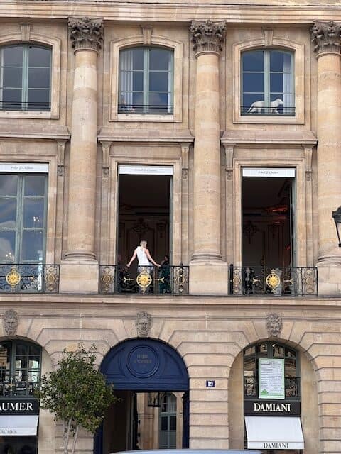 Model in a window by the Ritz Carlton in Paris, France