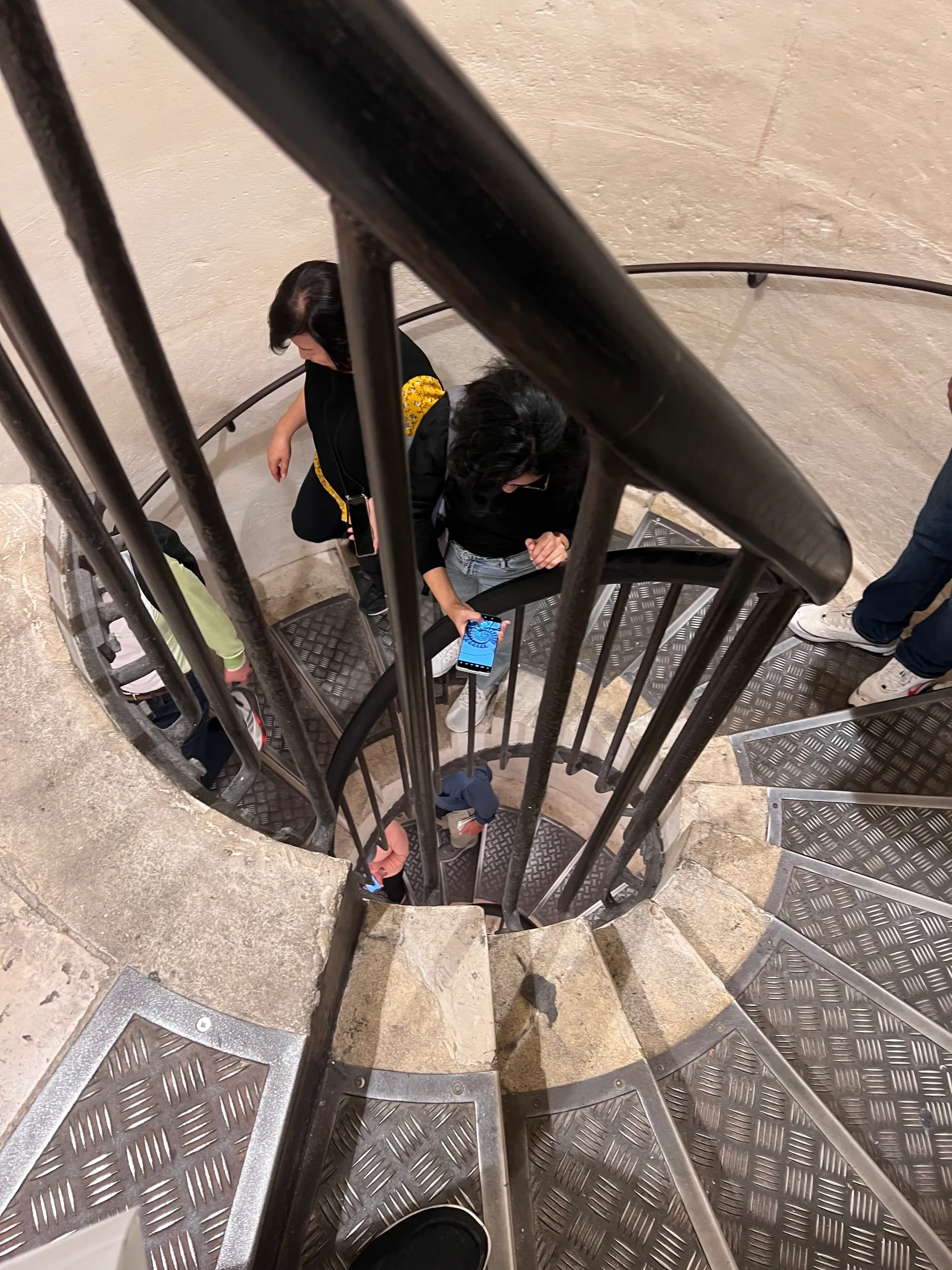 Climbing down the stairs from the Arc de Triomphe. Booking tickets to Paris Attractions. 