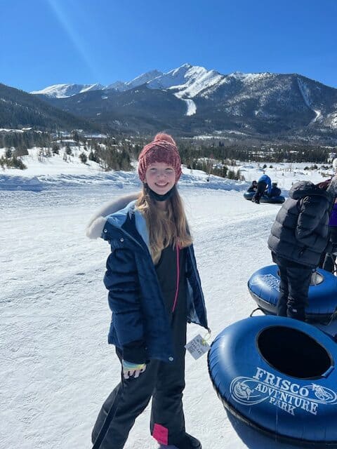 Kid snow tubing at the Frisco Adventure Park in Frisco, Colorado