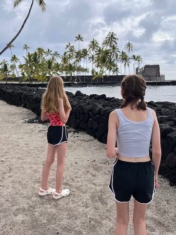 Girls in the sand at Two Step Beach on the Big Island of Hawaii