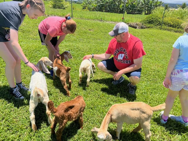 Petting the goats at the Honomu Goat Dairy Farm in Hilo, Hawaii