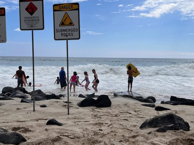 Surf warning signs at Magic Sands Beach in Kona, Hawaii