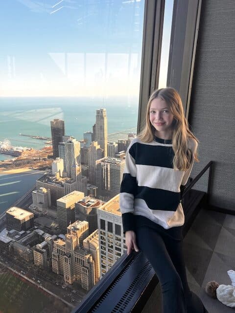 Posing with the Chicago skyline at the 360 observation deck in Chicago