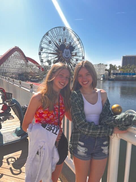 Girls posing in front of the ferris wheel at California Adventure