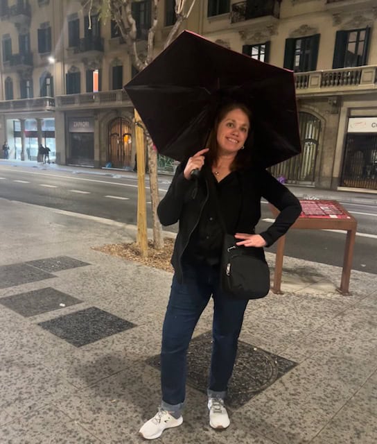 Posing in the rain with an umbrella in Barcelona, Spain