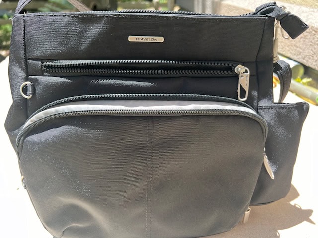 Showing front zipper pockets on the Travelon Anti-Theft purse