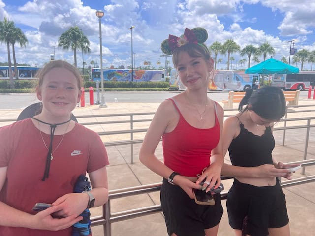 Girls waiting for the shuttle bus at Disney World