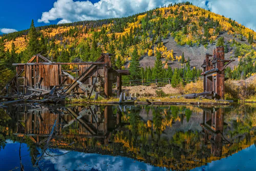 View of the Reiling Dredge old mining  ruins and hill with fall foliage in the background 